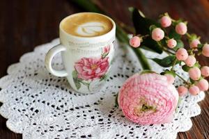Cappuccino in vintage cup with flowers photo