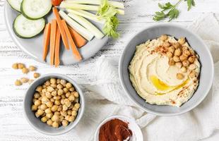 Top view hummus with chickpeas and vegetables photo