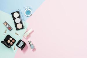 Overhead view of cosmetic products on pastel background