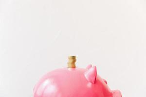 Stacked golden coins on a pink piggy bank photo