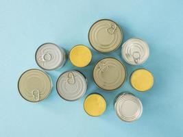 Top view canned food donation on blue background