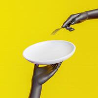 Empty plate for product display held by hand with a fork on yellow background photo