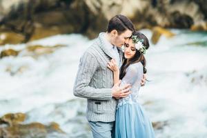 Young couple in love on a mountain river photo