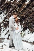 Bride and groom on the mountain waterfall photo