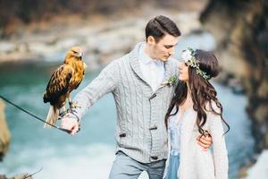 Young couple in love on a mountain river photo