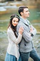 Young couple in love on a mountain river photo