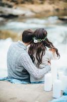 Young couple in love on a mountain river photo