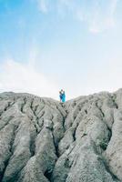 Blonde girl in a light blue dress and a guy in a light shirt in a granite quarry photo