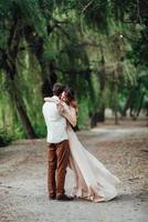 A guy and a girl are walking along the banks of a wild river overgrown photo