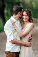 A guy and a girl are walking along the banks of a wild river overgrown photo