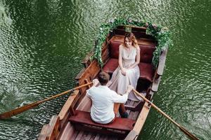 A boat trip for a guy and a girl along the canals and bays of the river photo