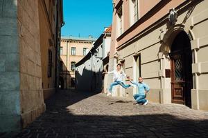 Guy and a girl happily walk in the morning on the empty streets photo