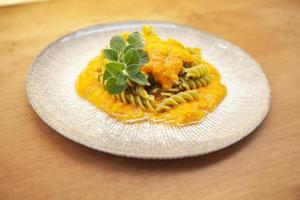 Plate of fusilli with pea flour in pepper sauce photo