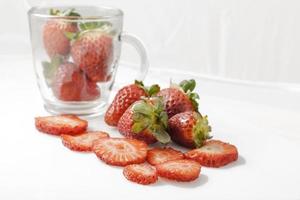 Sliced strawberries with white background photo