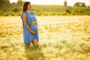 Pregnant woman at golden hour photo