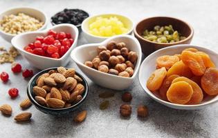 Bowls with various dried fruits and nuts photo