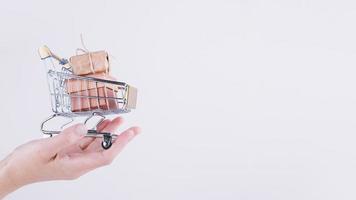 person holding small grocery cart with gift boxes . High quality and resolution beautiful photo concept