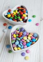 Bowls with multicolored dragee candies photo