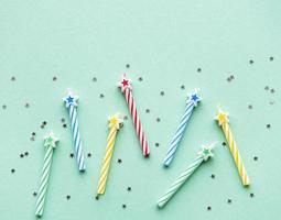 Birthday candles on pastel green background