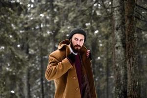 man in the winter forest photo