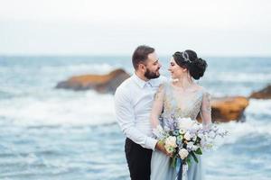 same couple with a bride in a blue dress walk photo