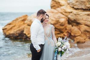 same couple with a bride in a blue dress walk photo