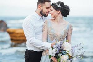 same couple with a bride in a blue dress walk photo