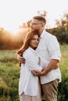 young couple in love a guy with a beard and a girl with dark hair in light clothes photo