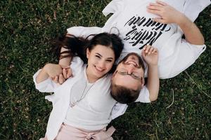 young couple in love a guy with a beard and a girl with dark hair in light clothes photo