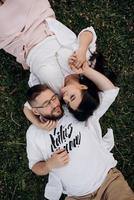 young couple in love a guy with a beard and a girl with dark hair in light clothes photo