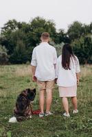 Big dog for a walk with a guy and a girl photo
