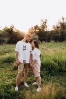 young couple in love a guy with a beard and a girl with dark hair in light clothes photo