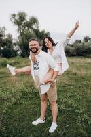 young couple in love a guy with a beard and a girl with dark hair in light clothes photo