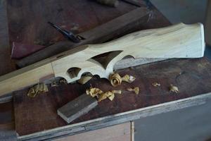 Craftsmanship of carved wooden gun. Woodwork photo