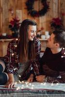 guy and a girl celebrate the new year together and give each other gifts photo