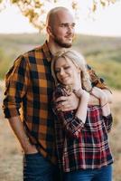 Cheerful guy with a board and a blonde girl for a walk in plaid shirts photo