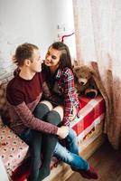 guy and a girl celebrate the new year together and give each other gifts photo