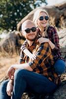 Guy and girl in caged shirts and trekking shoes photo