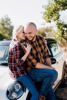 traveling by car of a young couple of a guy and a girl photo