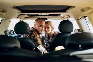 traveling by car of a young couple of a guy and a girl photo