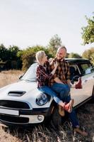 traveling by car of a young couple of a guy and a girl photo