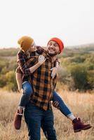 Cheerful guy and girl on a walk in bright knitted hats photo