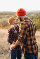 Cheerful guy and girl on a walk in bright knitted hats photo