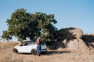 traveling by car of a young couple of a guy and a girl photo