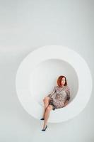 red haired model girl on a white circle background photo