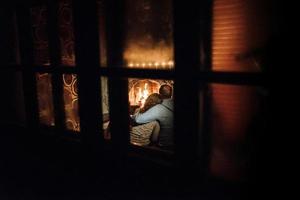 guy and girl are sitting on the background of a burning fireplace photo