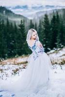 bride in white in the mountains Carpathians photo
