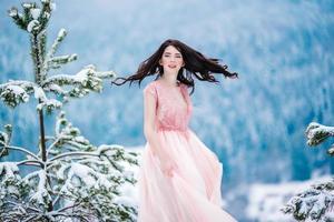 bride with chestnut hair blue background of the winter mountains photo