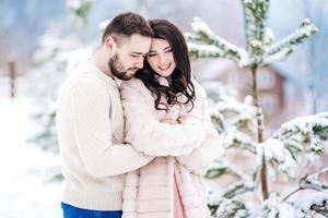 young couple on a walk in the snowy mountains photo