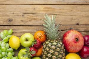 Fresh fruits on a wooden table photo